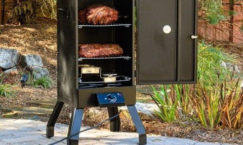 Masterbuilt Analog Electric Smoker with food inside and on the patio.