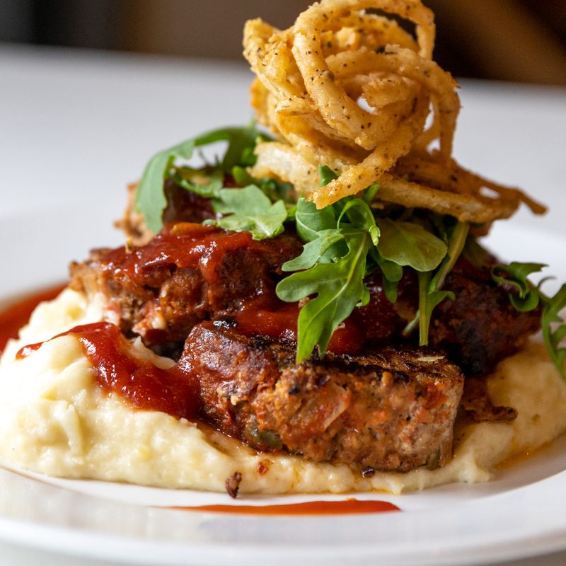 Meatloaf, garlic mashed potatoes, and crispy onion straws from Joy's Cafe