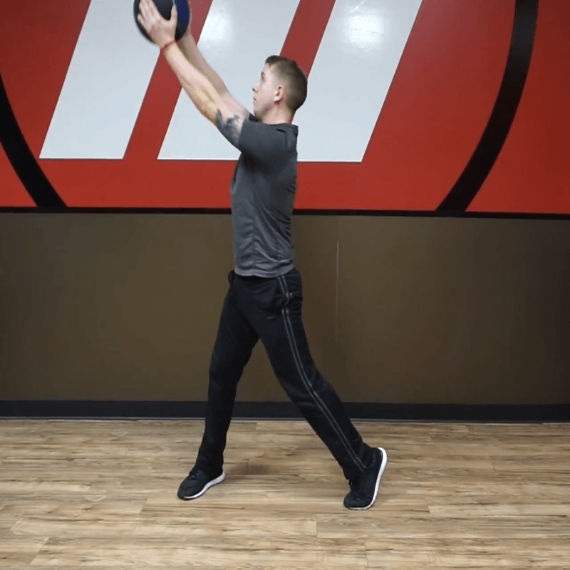 An athlete doing medicine ball chops.