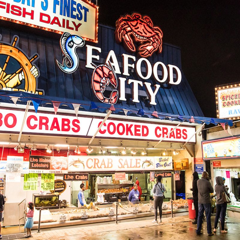 The Municipal Fish Market bustling with people at night.