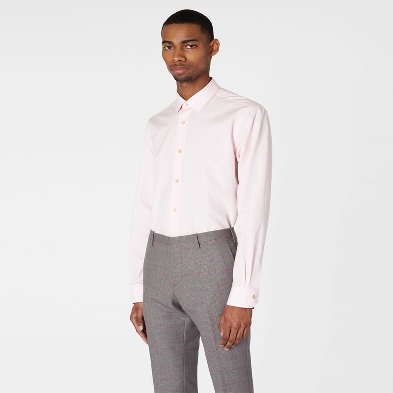 A male model wearing a pink cuff shirt from Paul Smith.