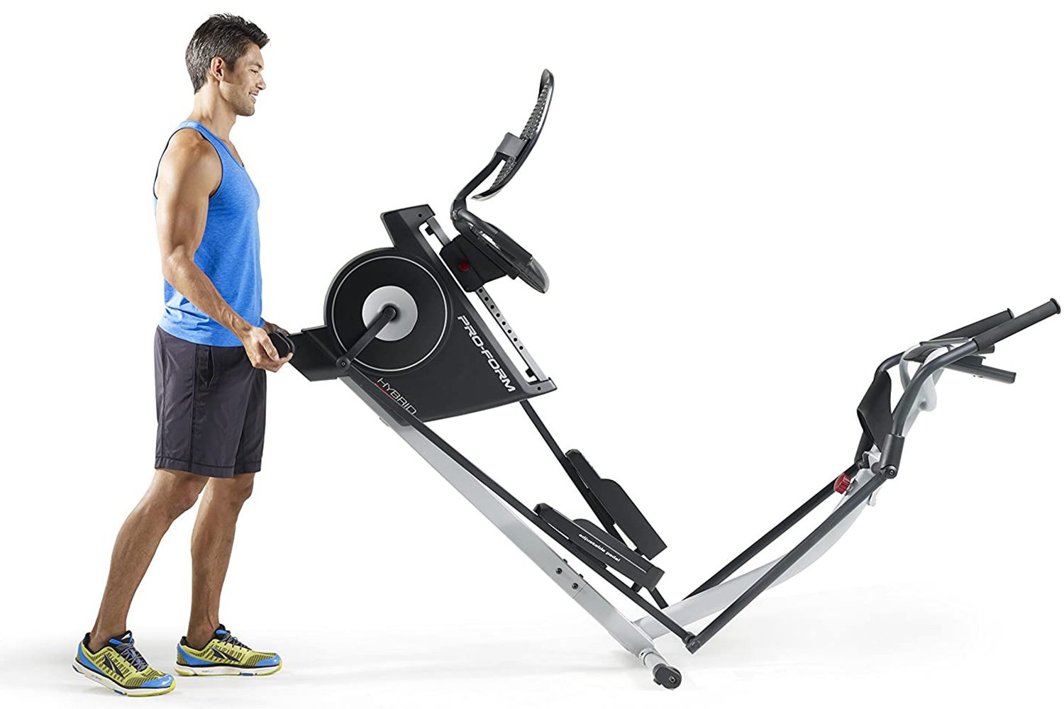 Man picking up back of Proform Elliptical on white background.