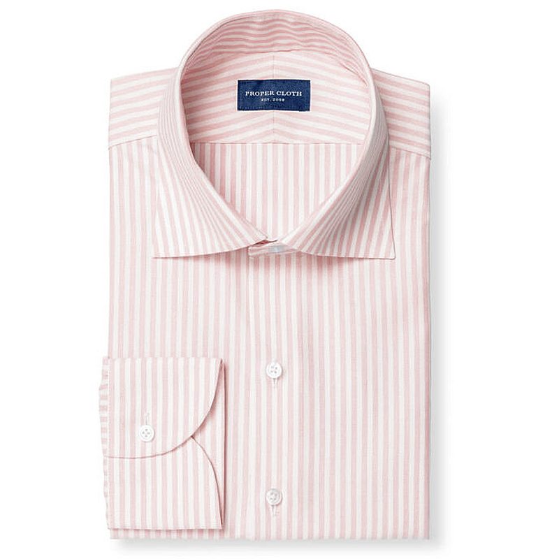 A folded dress shirt with pink stripes.