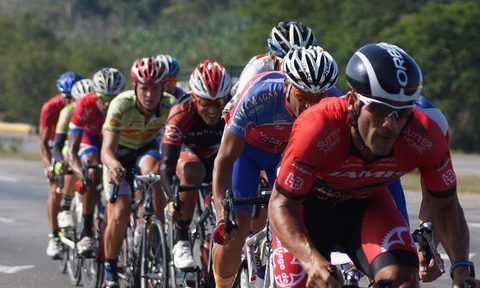 Peloton of men cycling on the road