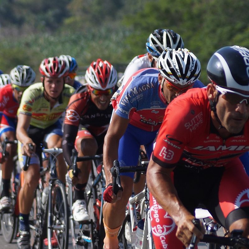 Peloton of men cycling on the road