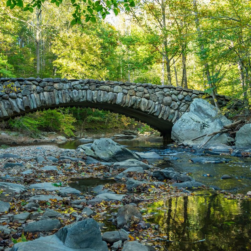 A bridge and rock formations on Rock Creek Park.