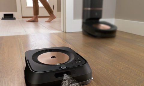 iRobot Roomba S9 Plus robot vacuum with Braava Jet M6 robot mop in use to clean floor.
