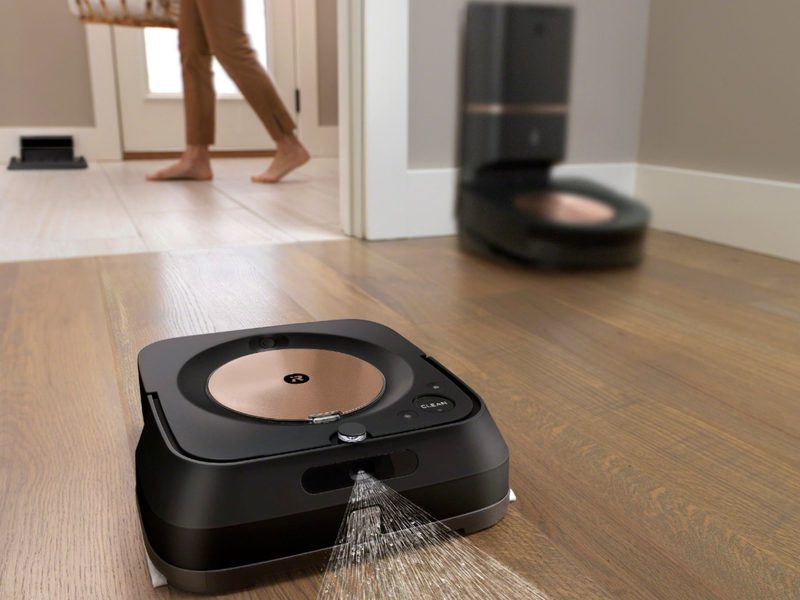 iRobot Roomba S9 Plus robot vacuum with Braava Jet M6 robot mop in use to clean floor.
