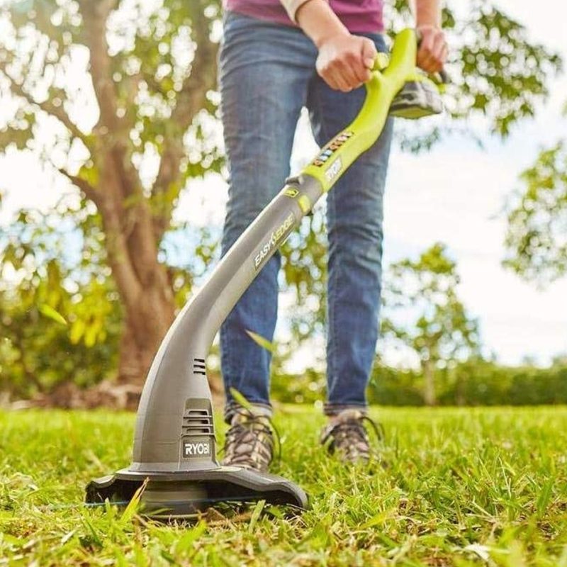 Using a Ryobi String Trimmer on a lawn.