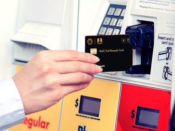 Someone paying for gas at Shell pump with credit card.