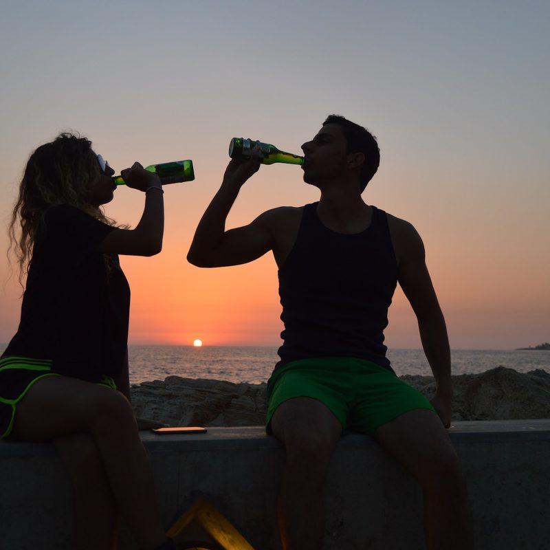 Couple drinking at sunset