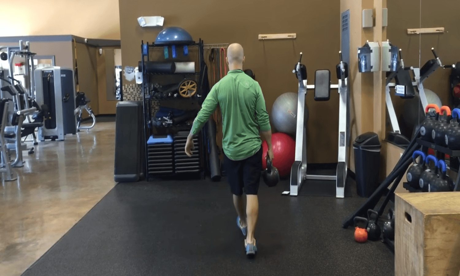 Luke Andrus performing the Single-Arm Farmer&rsquo;s Carry.