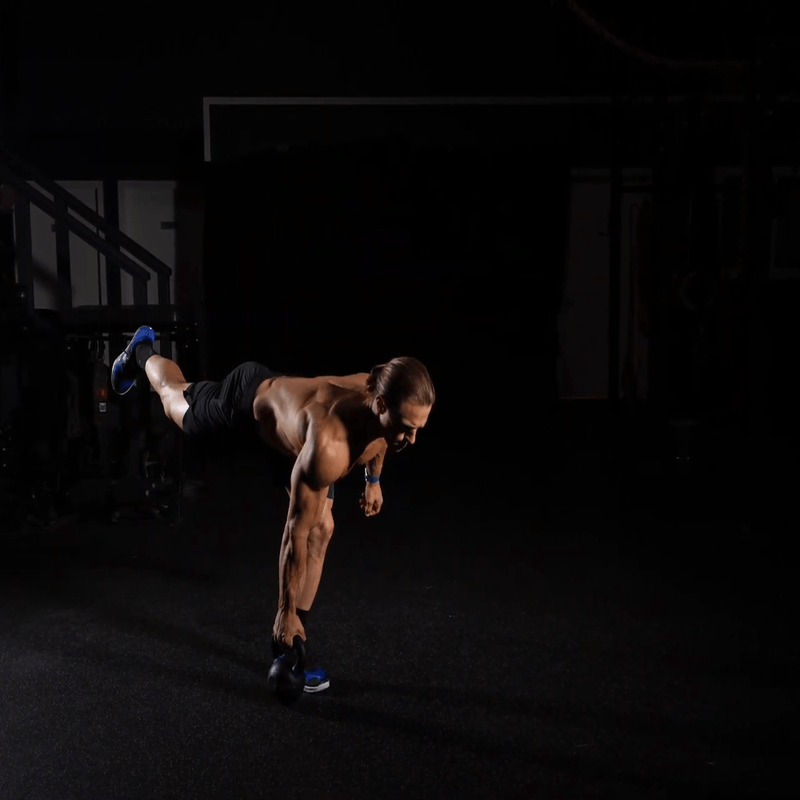 Marcus Filly performing a single-leg deadlift with a kettlebell.