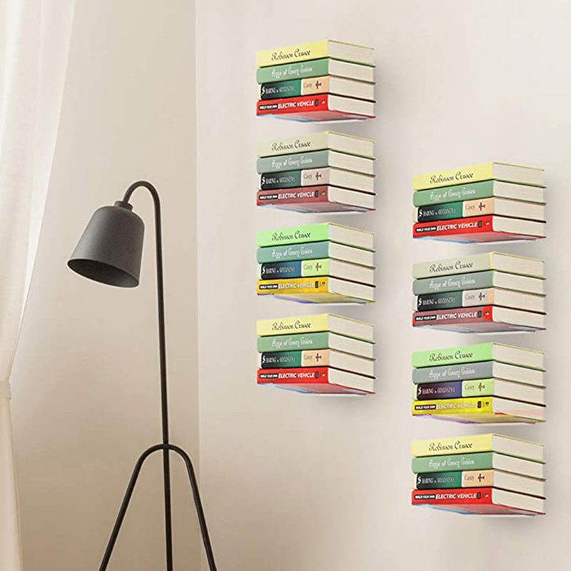 Books on Storage Maniac Floating Bookshelves beside a black lampshade.