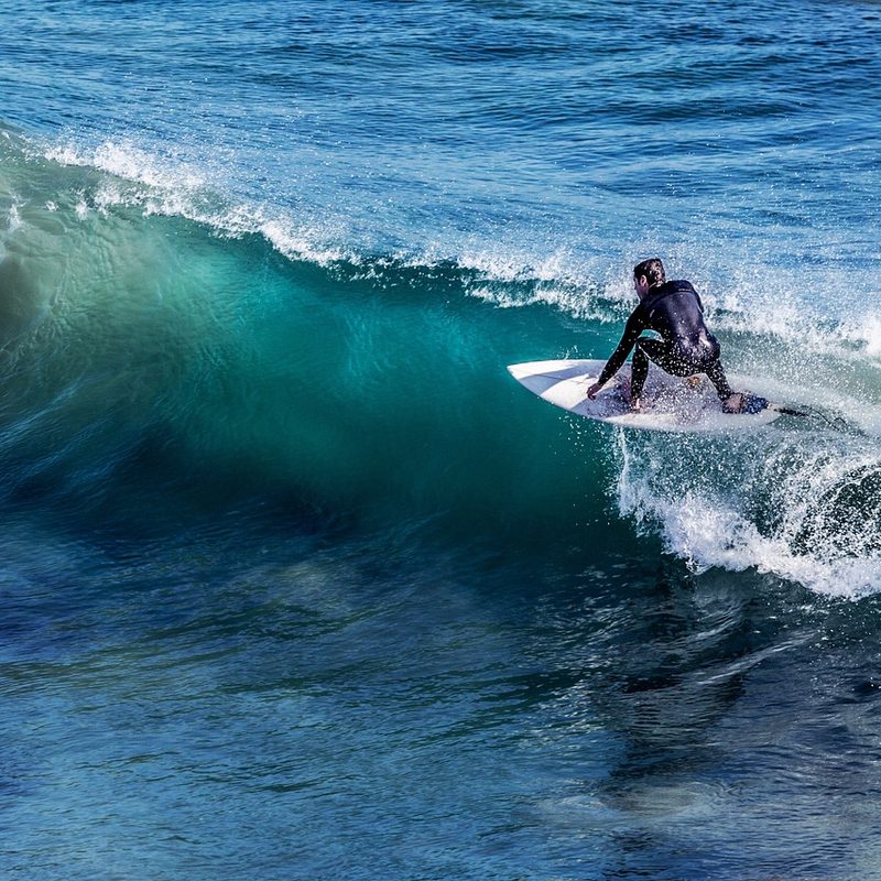 surfer in a wetsuit riding a wave .