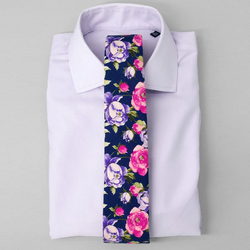 A floral tie on a folded lavender dress shirt from Tie Bar.