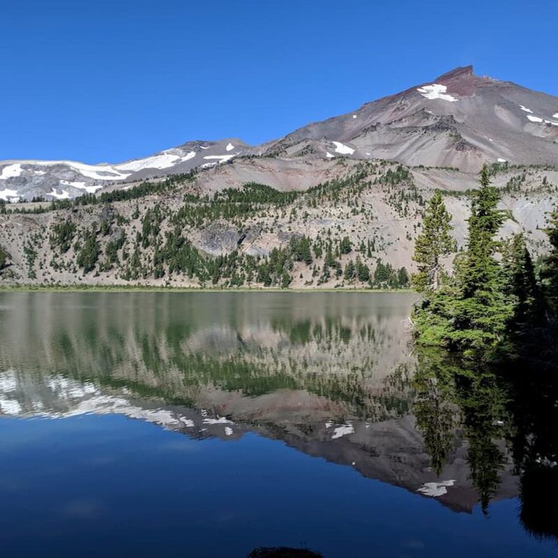 A pristine reflection of South Sister in Green Lake at day.