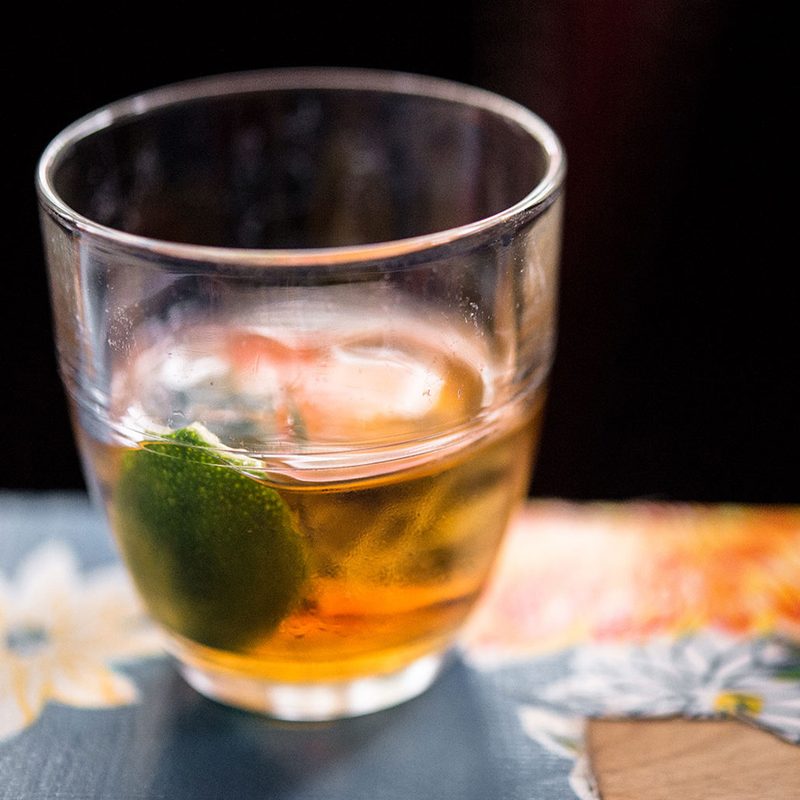 A cup of Ti-Punch on a floral tablecloth