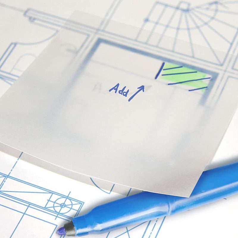 A transparent sticky note with the word "add" on a blueprint beside a blue pen.