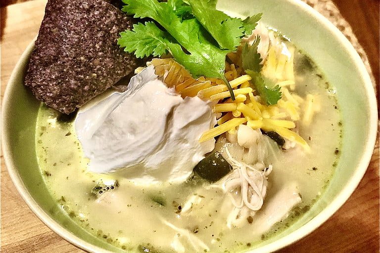 White Chicken Chili in a bowl with cilantro garnish.