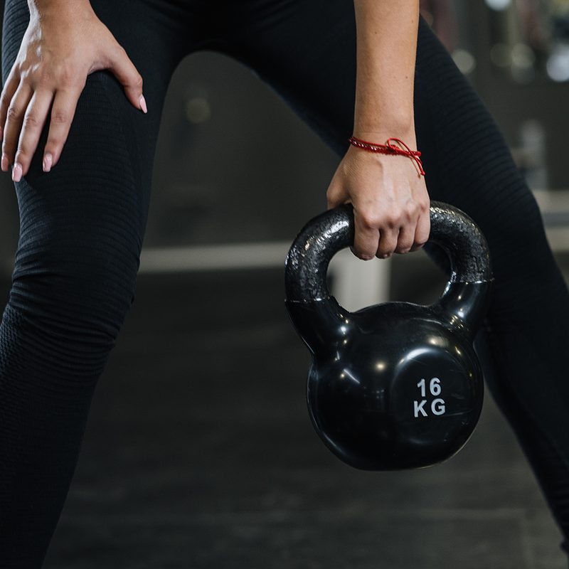 Woman doing kettlebell squat.