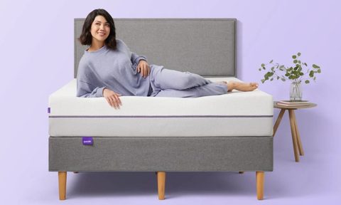 A smiling person on a Purple mattress.