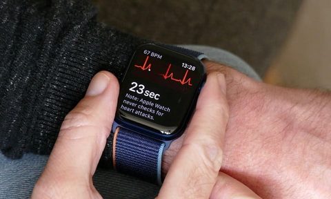 Apple Watch Series 6 on wrist with ECG displayed.