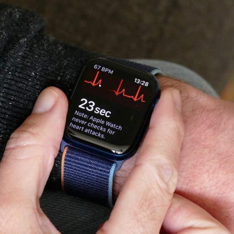Apple Watch Series 6 on wrist with ECG displayed.