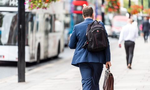 A businessman with backpack and briefcase