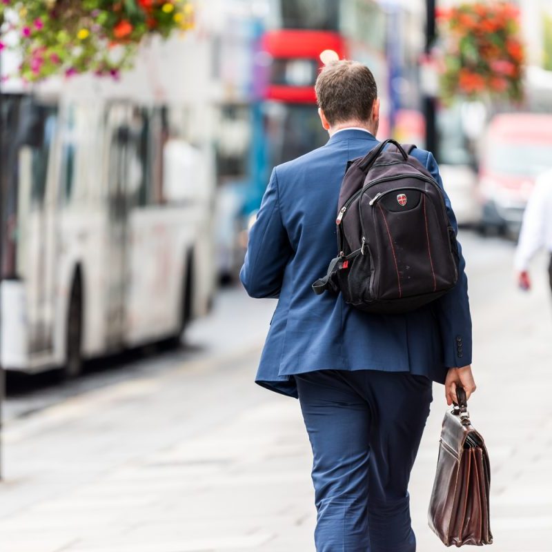 A businessman with backpack and briefcase