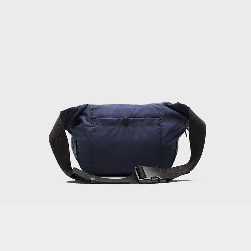 A blue Banana Republic Crossbody Belt Bag on gray background.