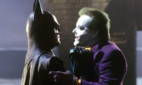 Batman lifting The Joker by the collar.