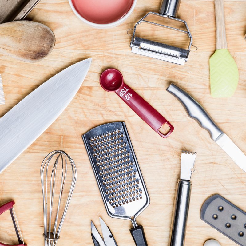 Assorted kitchen utensils on a wooden table.