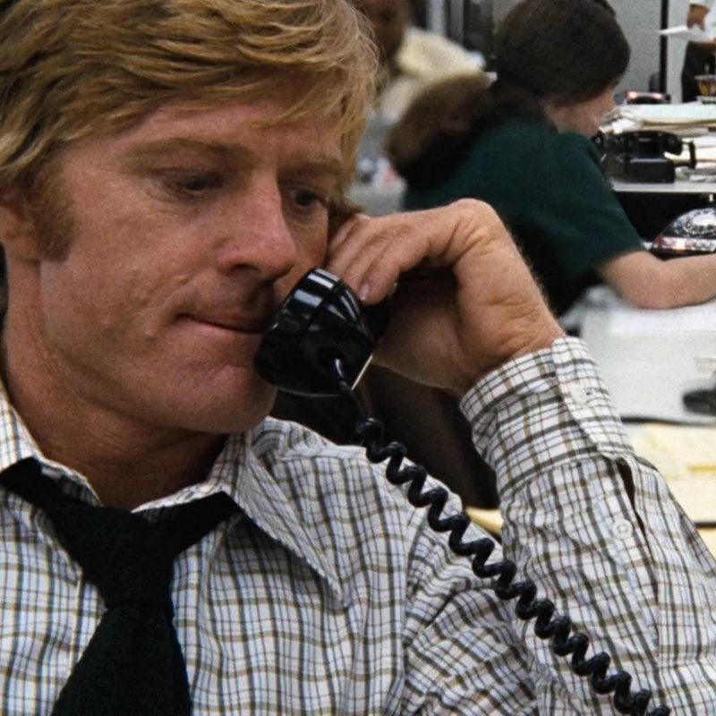 Robert Redford in All the President's Men answering the telephone.