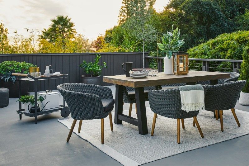 A boden bar cart in an outdoor dining setting.