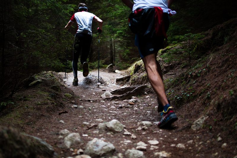 Two men trail running.