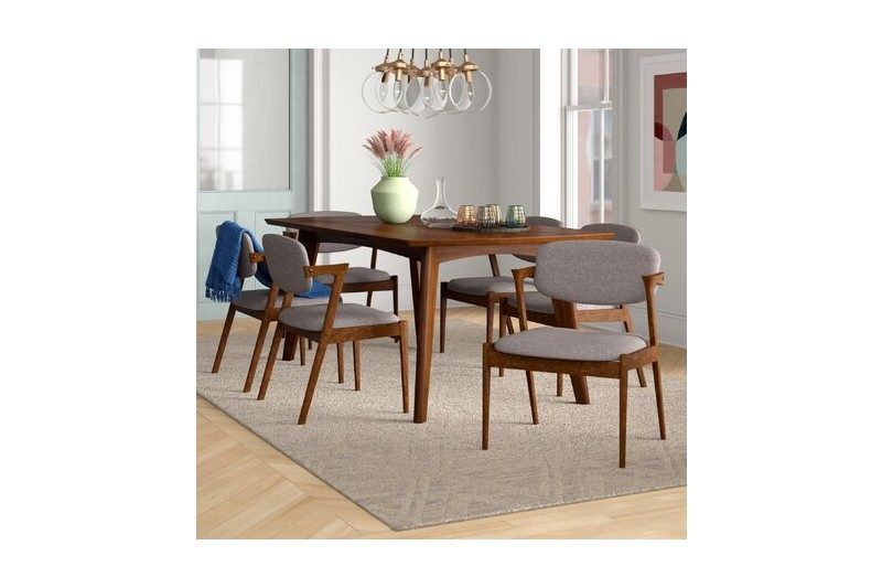 George Oliver's 7 Piece Dining Room Set with chairs messily set up.