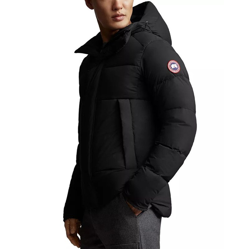 A male model wearing a black Canada Goose Armstrong Down Puffer Jacket.