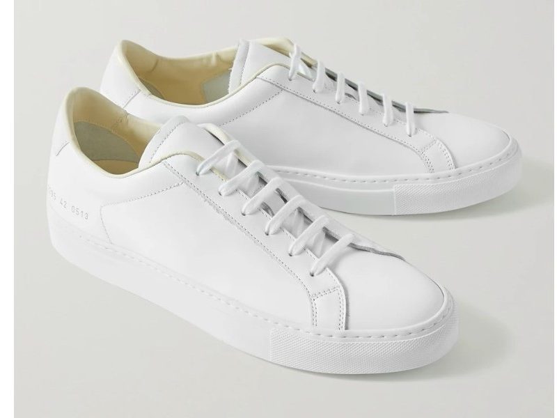 Common Projects Retro Low Leather Sneakers on a gray background.