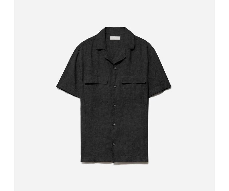 A black Everlane Linen Camp Shirt on a light gray backdrop.