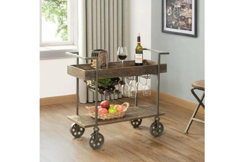 The farmhouse bar cart with wine and basket of fruit.