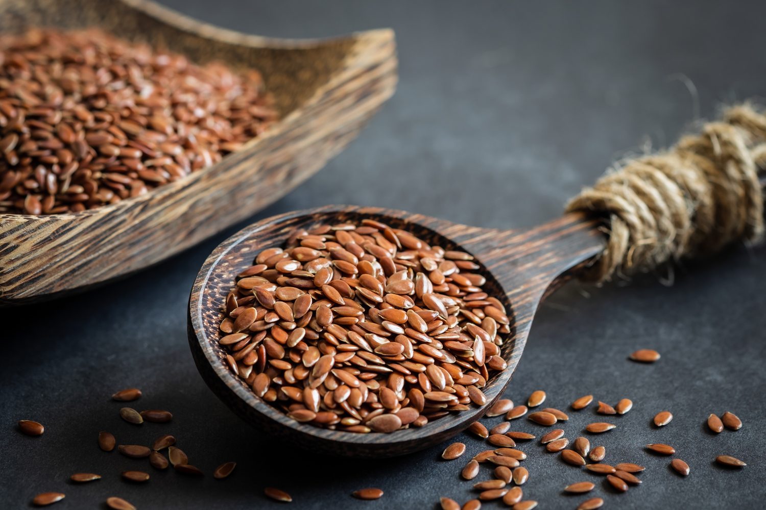Flax seeds on wooden spoon.