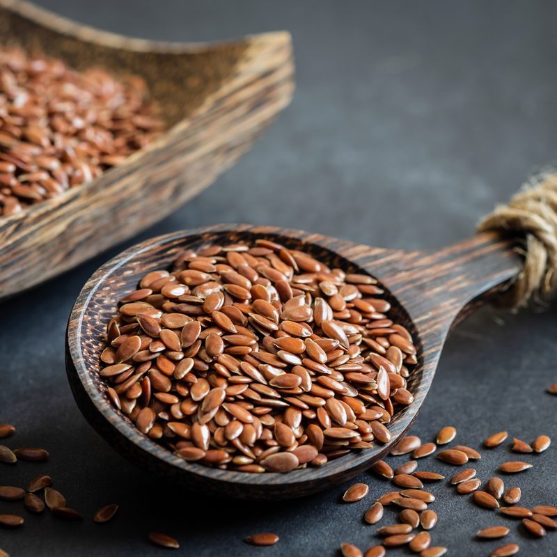 Flax seeds on wooden spoon.