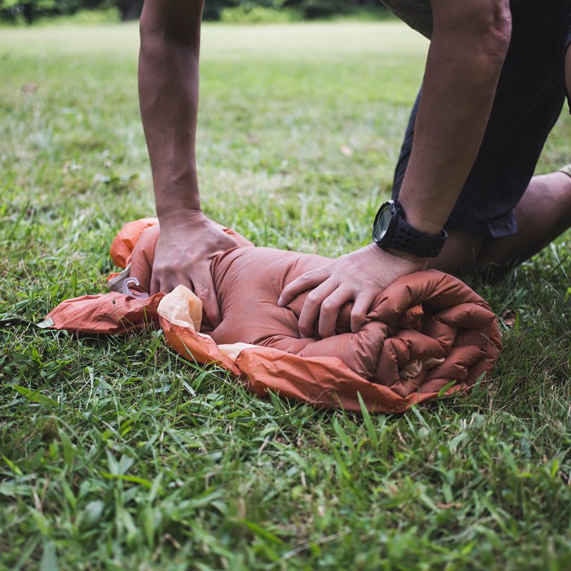 Man rolling tent.