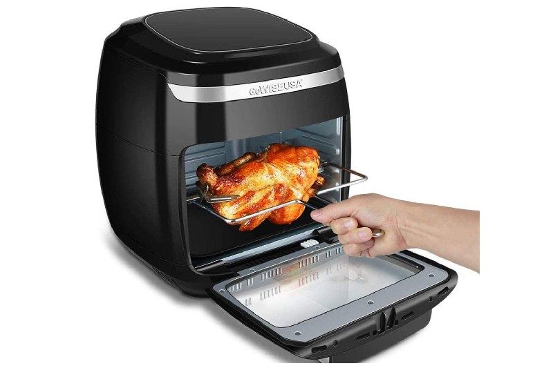 Man pulling chicken out of oven air fryer from GoWise.