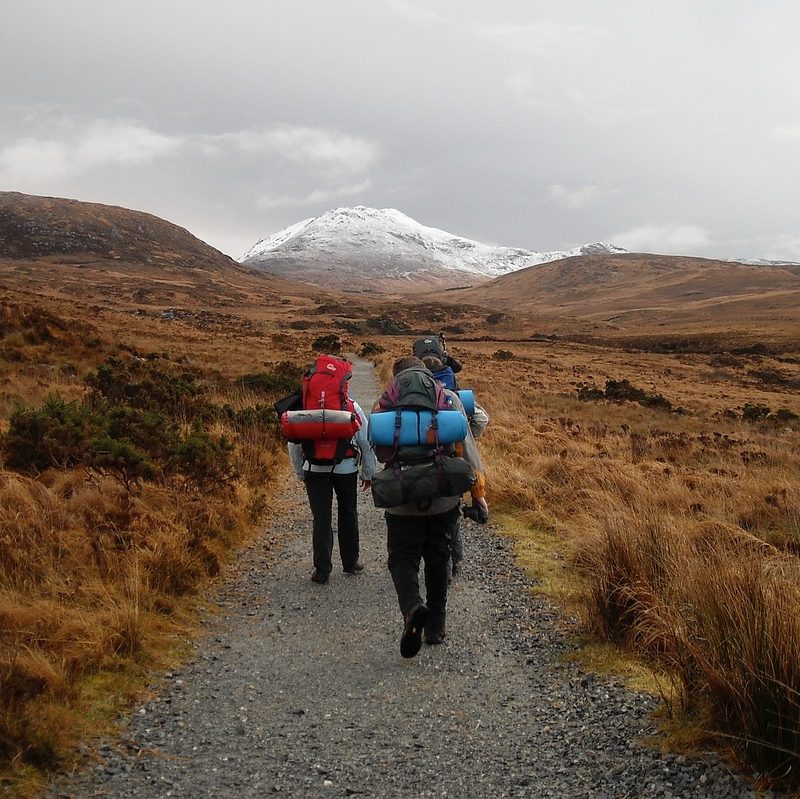 Group of people hiking with short-term backpacks.