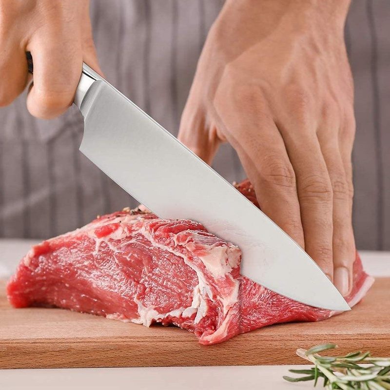 Imarku chef knife used to cut a juicy steak.