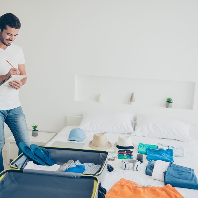 A man using a checklist to prepare for a trip.