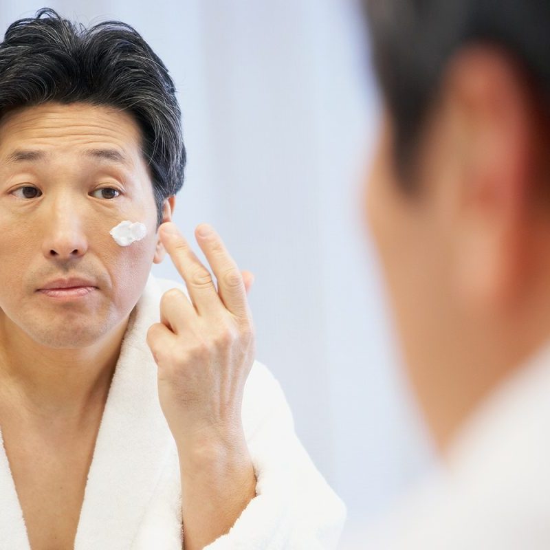 Man applying face cream.