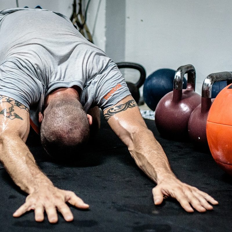 Man stretching in child's pose.